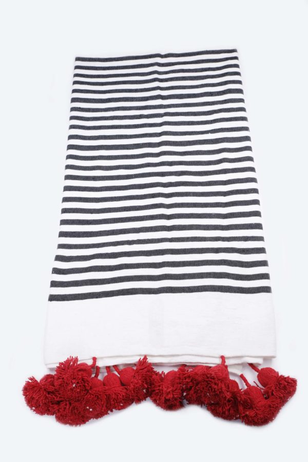 White blanket with red tassels